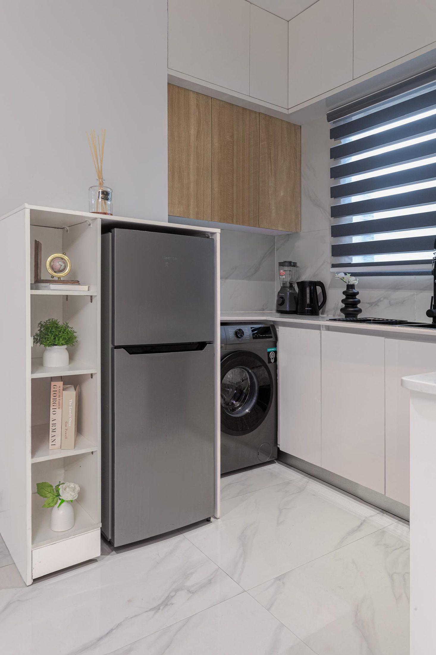Compact white kitchen with oak wall cabinets, open shelving and integrated laundry space